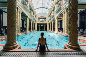 Topdeck traveler dipping into the waters of the Szechenyi Thermal Baths in Budapest.