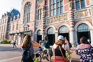 Topdeck travelers mounting bicycles for a tour outside the Van Gogh Museum in Amsterdam.