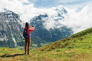 A Topdeck traveler looks out over the snow topped mountains of the Swiss Alps.