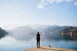 Topdeck Traveler standing in front of Slovenia's iconic Lake Bled.