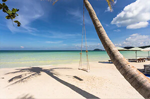 A view of a beach with some beach chairs laid out on Pho Quoc Island in Vietnam.