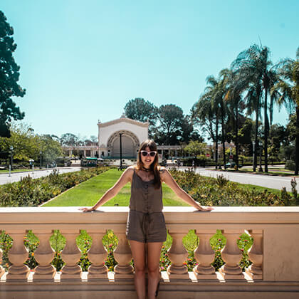 Topdeck traveler posing in the middle of San Diego's Balbao Park.