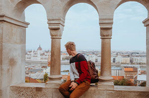 Topdeck traveler on a ledge at Fisherman's Bastion in Budapest.