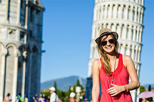 Topdeck traveler posing for a photo in front of Leaning Tower of Pisa.