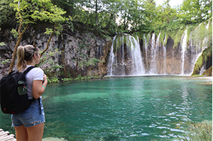 A Topdeck Traveler looks out over the small waterfalls pouring into Pllitvice Lakes National Park.