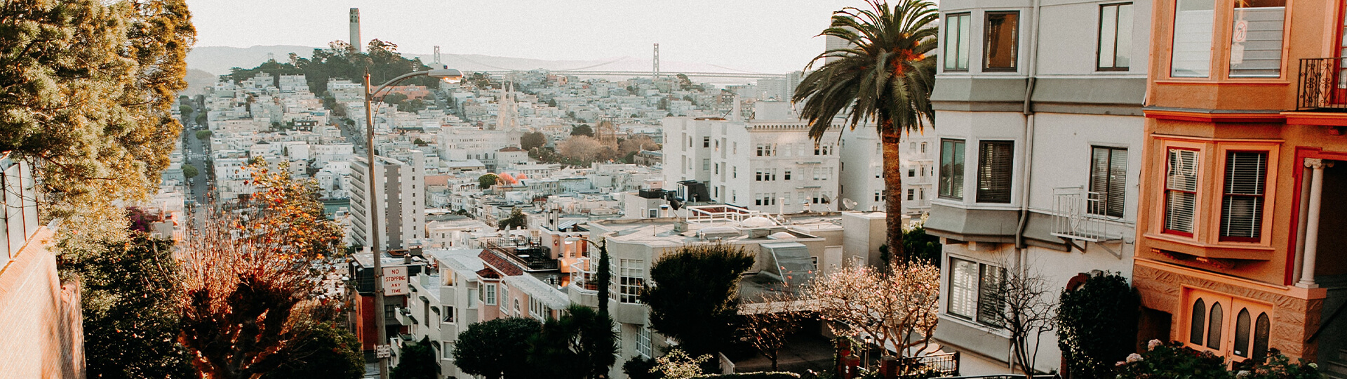 An aerial view of the San Francisco cityscape with the Golden Gate bridge in the background.