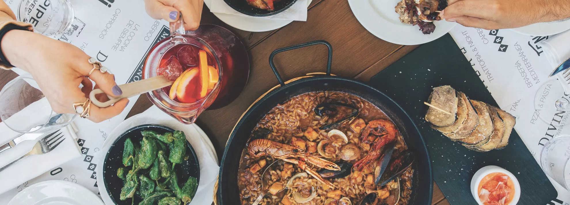plates of food with people serving themselves food from different dishes