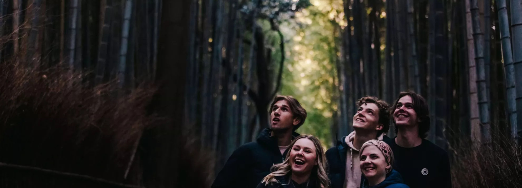 A group of people in woodlands smiling