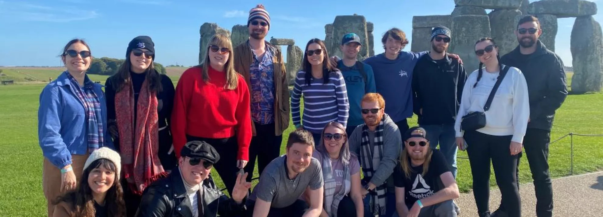 A group of topdeckers in front of Stonehenge