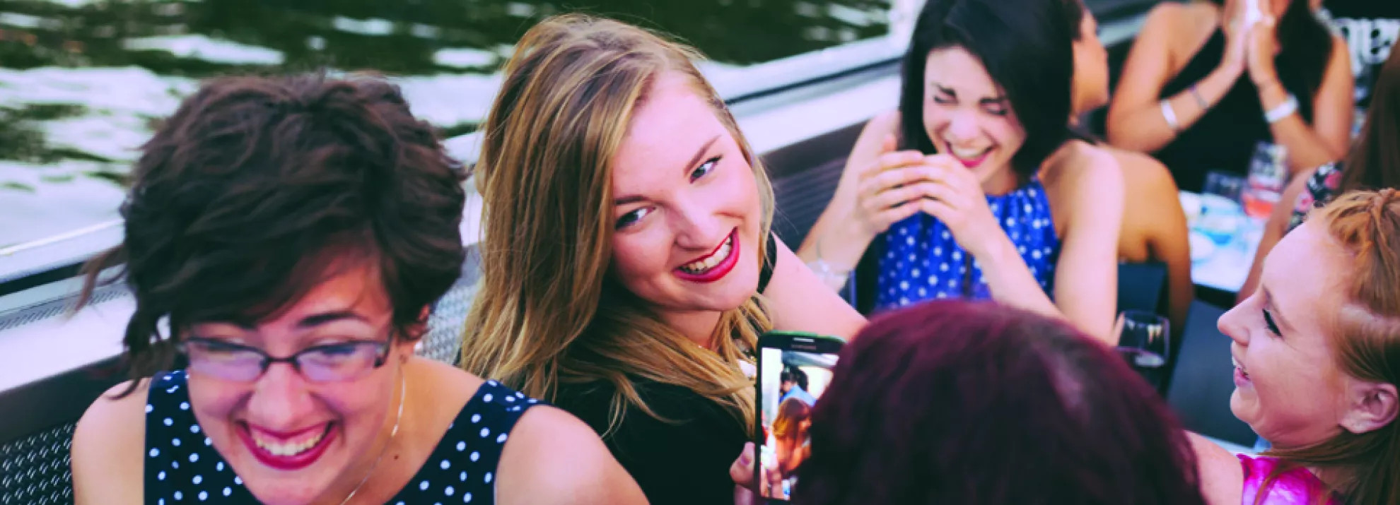 A group of women smiling and laughing on a boat in The Netherlands