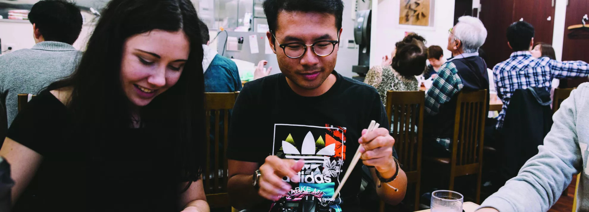 Three people eating at a Japanese restaurant 