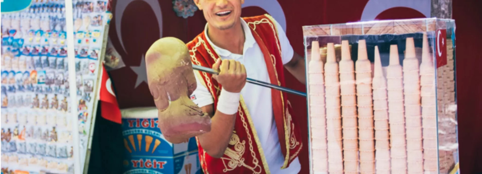 Man selling ice cream on a stick at a stand