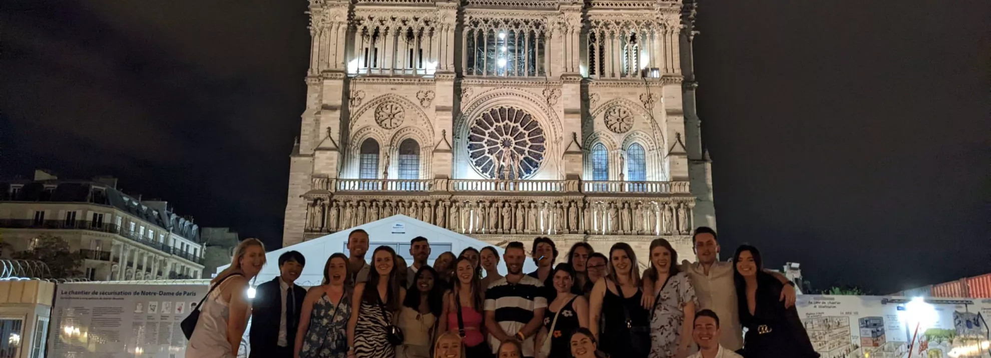 A group of topdeckers in front of a church