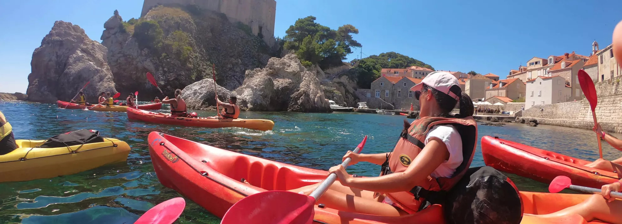 People in canoe boats in the sea in Dubrovnik