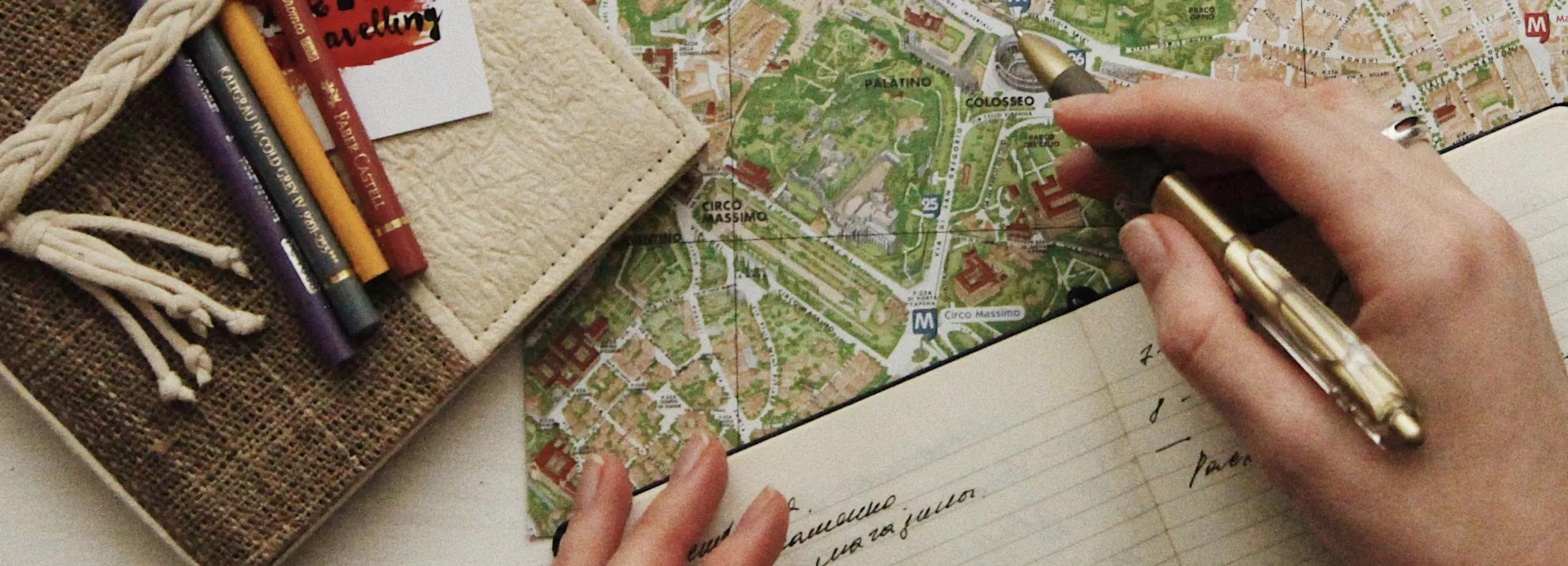 opened notebook with words on the page and a map on a table