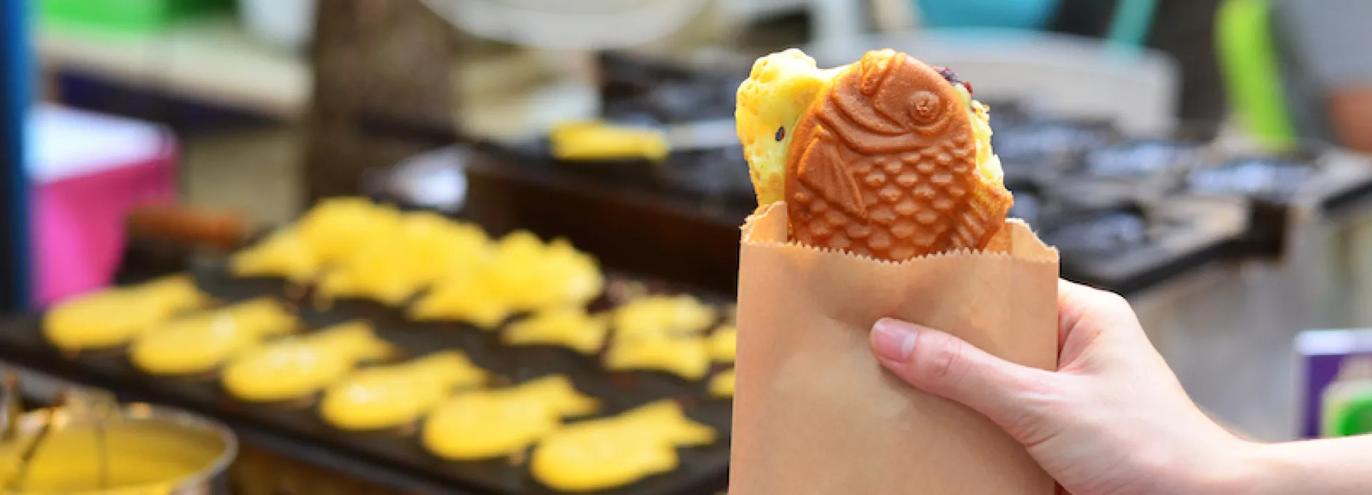 A person holding taiyaki cake