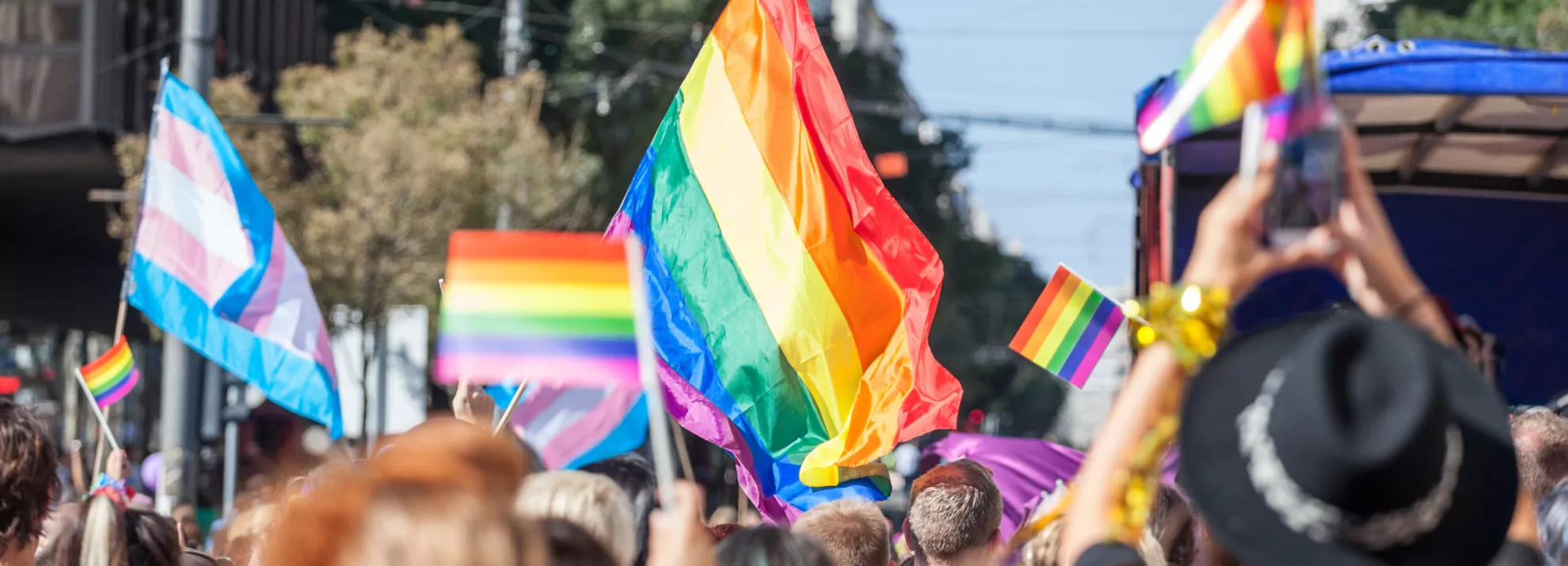 People holding up pride flags at a parade