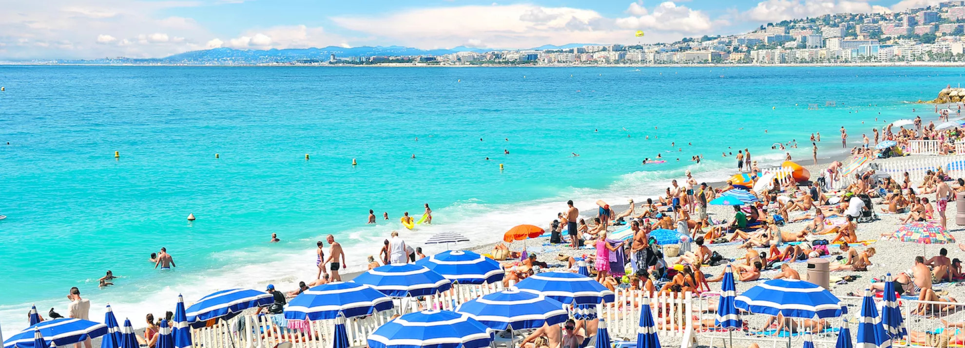 view of the beach with many sun loungers and umbrellas on it