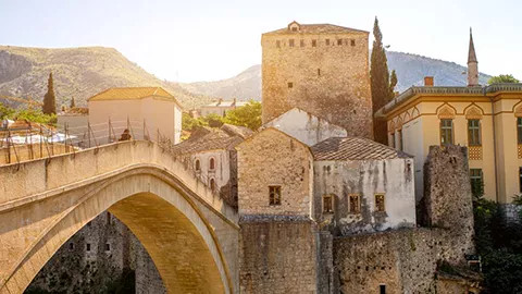 Large stone bridge with stone buildings.
