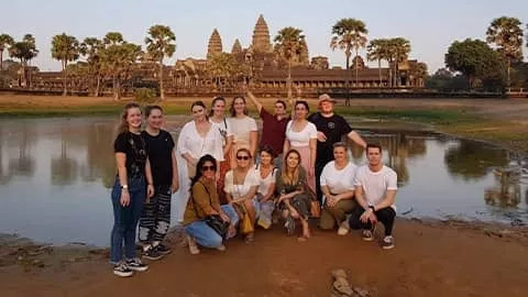 Group of people in front of Angkor Wat in Cambodia.