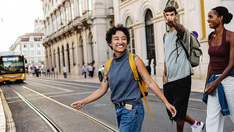 Three people crossing the street in Lisbon