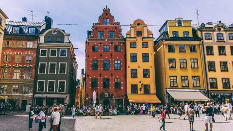Line of brightly coloured buildings in red, orange and yellow.