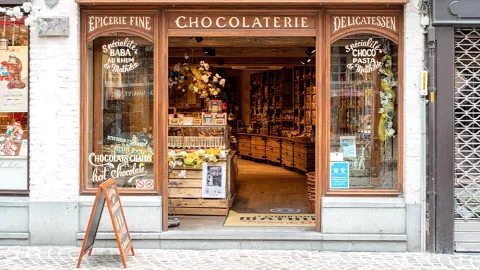 Shop front of Le Comptoir de Mathilde with brown wood details in France.