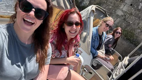 People smiling for a photo in a Tuk Tuk.