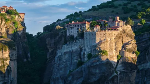 Varlaam Monastery sitting on the edge of a cliff in Meteora, Greece.