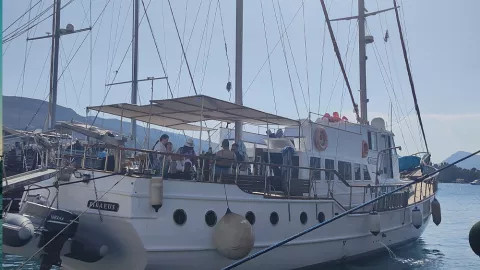 Sail boat with people on board in the Greek islands.