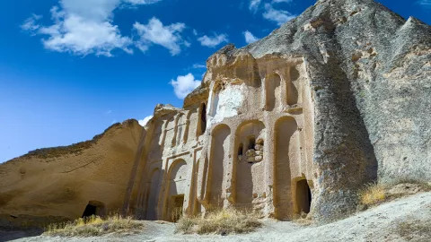 Front of church within a large rockface, known as the Selime Cathedral located in the Cappadocia region of Turkey.