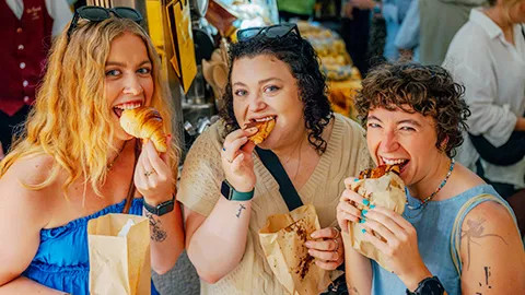 Topdeck customers eating croissants in Paris.