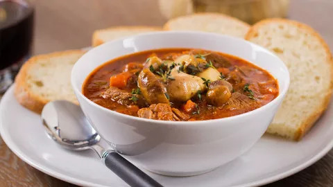 A bowl of Irish stew with soda bread.