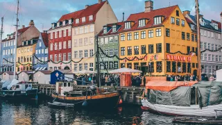 Boats and colorful houses line the docks of Nyhavn harbour in Copenhagen.