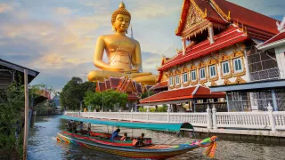 Golden Buddha statue at Wat Paknam Phasi Charoen temple in Bangkok.