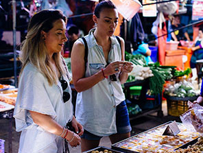 Topdeck Travelers trying out streetfood in a market during a tour through Thailand.