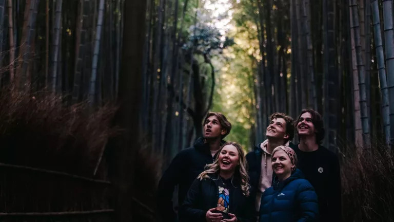 A group of people in woodlands smiling