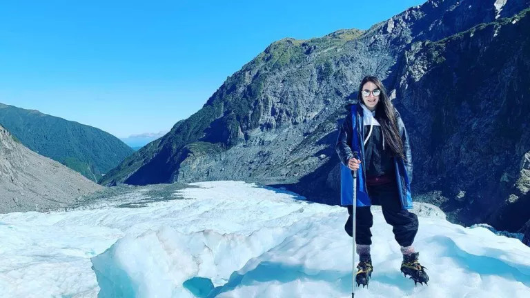 A woman standing in Fox Glacier, New Zealand South Island