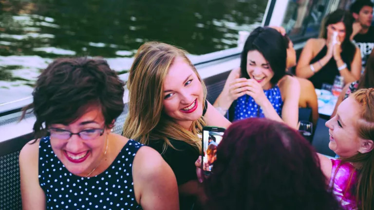 A group of women smiling and laughing on a boat in The Netherlands