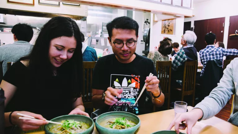 Three people eating at a Japanese restaurant 
