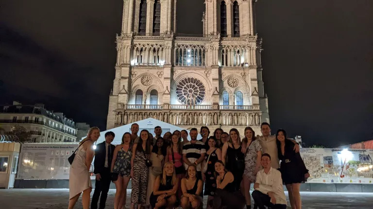 A group of topdeckers in front of a church
