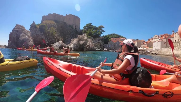 People in canoe boats in the sea in Dubrovnik