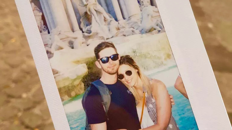 picture of a photograph of a man and woman couple embracing in front of the Trevi Fountain
