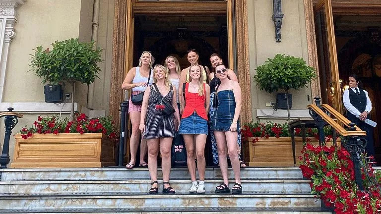 Small group standing together in the doorway of a European building.