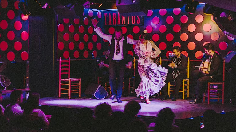 Flamenco performers dancing on stage at Los Tarantos in Barcelona, Spain.