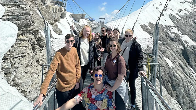 People posing together on a suspension bridge on the Titlis Cliff Walk.