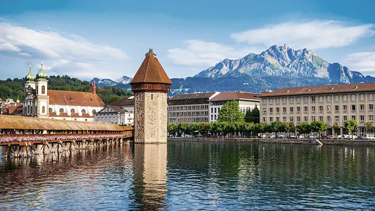 Chapel Bridge, in Lucerne with the Swiss Alps in the background.