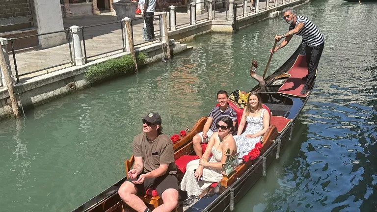Four people enjoying a Gondola ride in Venice