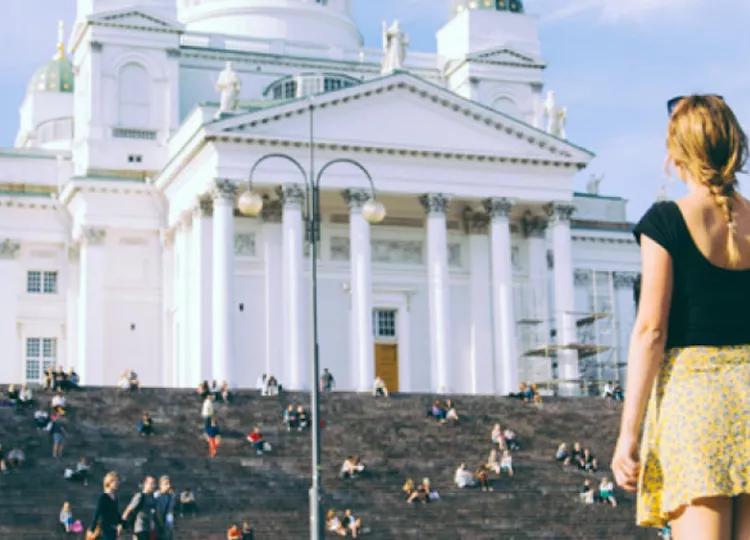 Topdeck Traveler looking at the snow white Helsinki Cathedral.