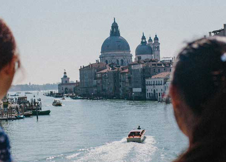 Two Topdeck travelers looking out over the famous Venice Canal.